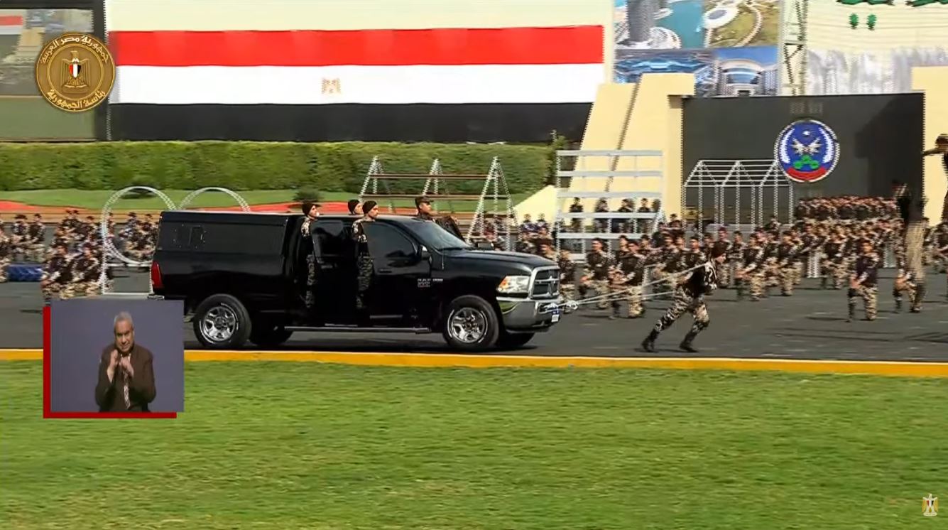 Police Academy cadets navigate fire obstacles and pull a 10-ton armored vehicle during their graduation ceremony.
