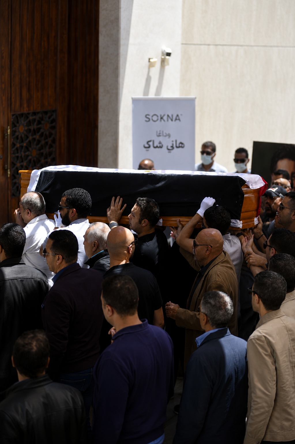 The Egyptian flag was draped around the body of Hani Shaker as it entered the mosque.